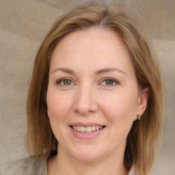 Joyful white adult female with medium  brown hair and grey eyes