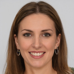 Joyful white young-adult female with long  brown hair and brown eyes