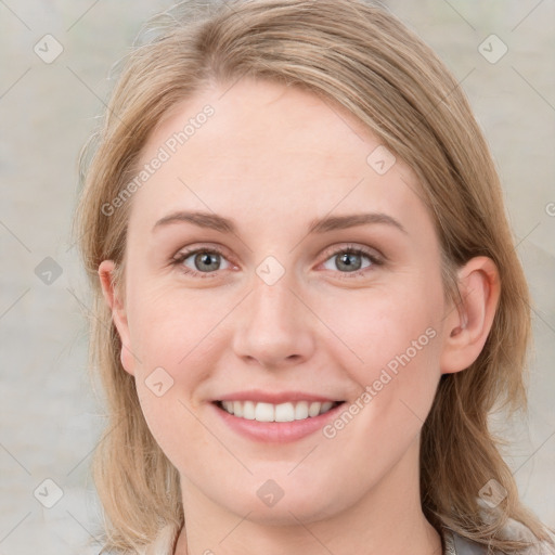 Joyful white young-adult female with medium  brown hair and blue eyes