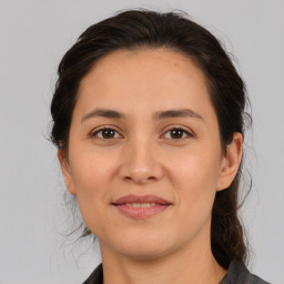 Joyful white young-adult female with medium  brown hair and brown eyes