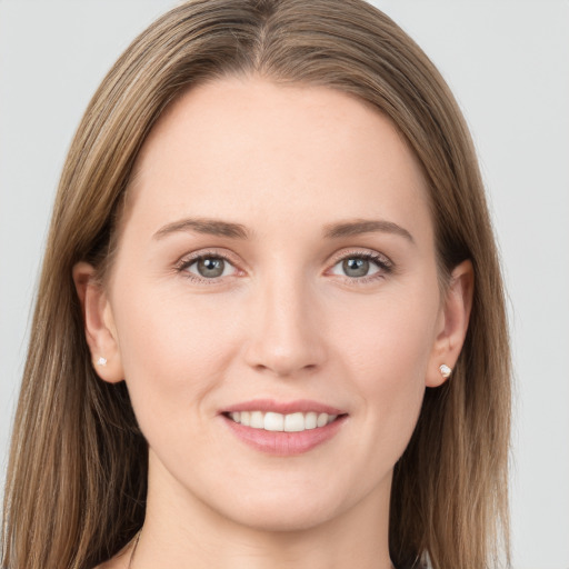 Joyful white young-adult female with long  brown hair and grey eyes