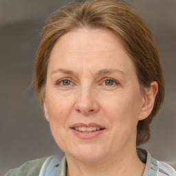 Joyful white adult female with medium  brown hair and blue eyes