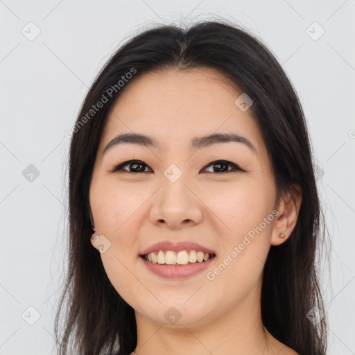 Joyful asian young-adult female with long  brown hair and brown eyes