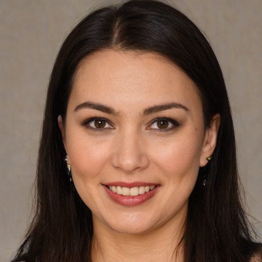 Joyful white young-adult female with long  brown hair and brown eyes