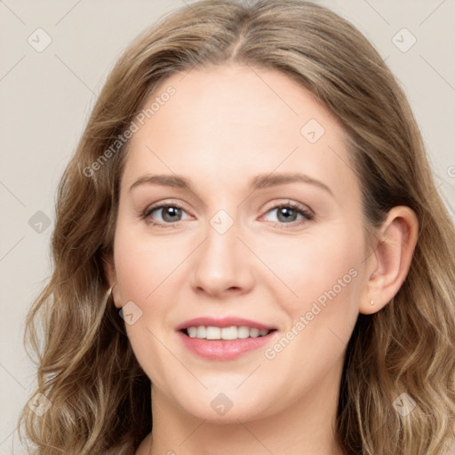 Joyful white young-adult female with long  brown hair and blue eyes