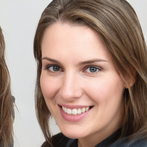 Joyful white young-adult female with long  brown hair and brown eyes