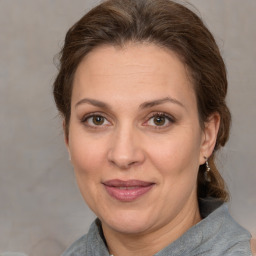 Joyful white adult female with medium  brown hair and brown eyes