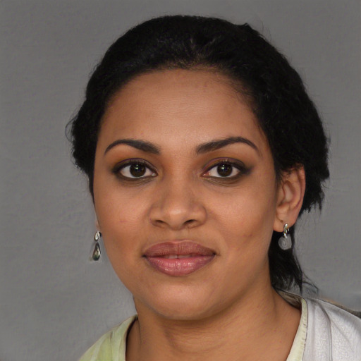 Joyful black young-adult female with medium  black hair and brown eyes