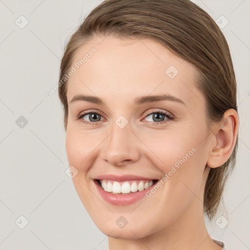 Joyful white young-adult female with long  brown hair and green eyes