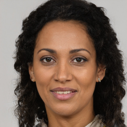 Joyful latino adult female with long  brown hair and brown eyes