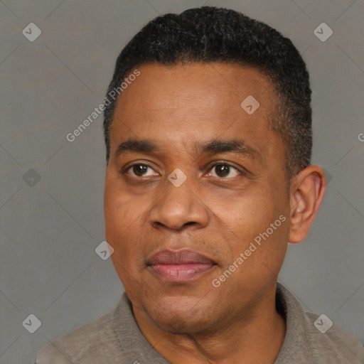 Joyful black adult male with short  black hair and brown eyes