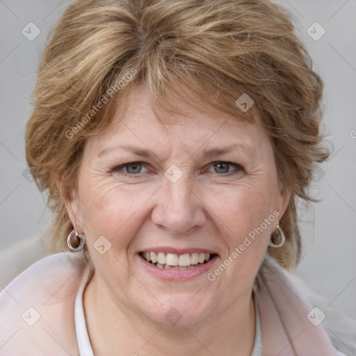 Joyful white adult female with medium  brown hair and blue eyes