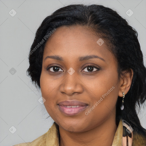 Joyful black young-adult female with long  black hair and brown eyes