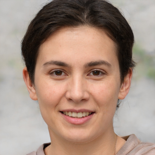 Joyful white young-adult female with short  brown hair and brown eyes