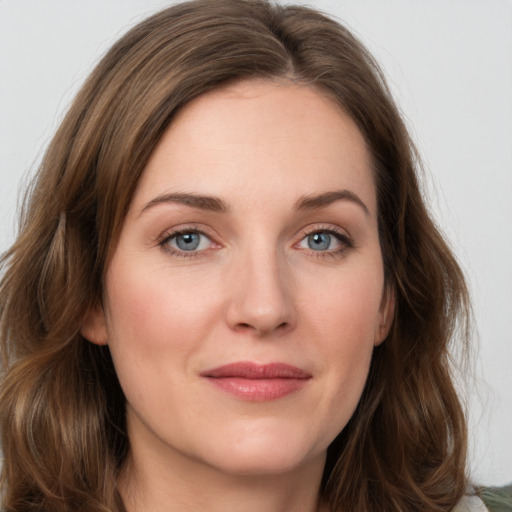 Joyful white young-adult female with long  brown hair and green eyes