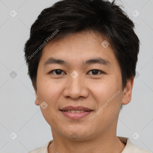 Joyful asian young-adult male with short  brown hair and brown eyes