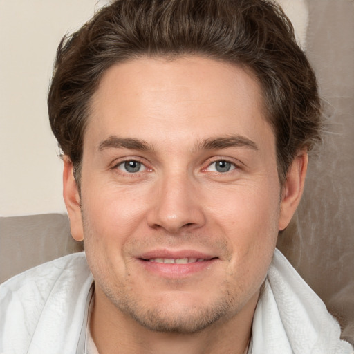 Joyful white adult male with short  brown hair and brown eyes