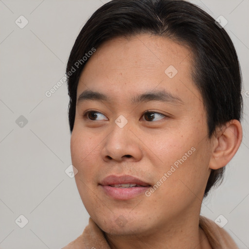 Joyful asian young-adult male with short  brown hair and brown eyes