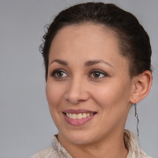 Joyful latino young-adult female with short  brown hair and brown eyes