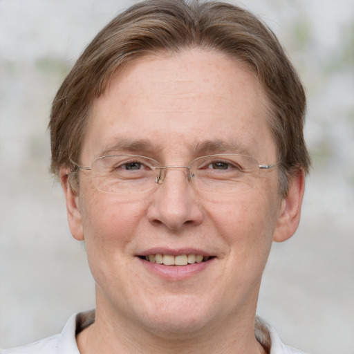 Joyful white adult male with short  brown hair and grey eyes