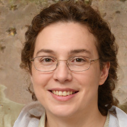 Joyful white adult female with medium  brown hair and blue eyes