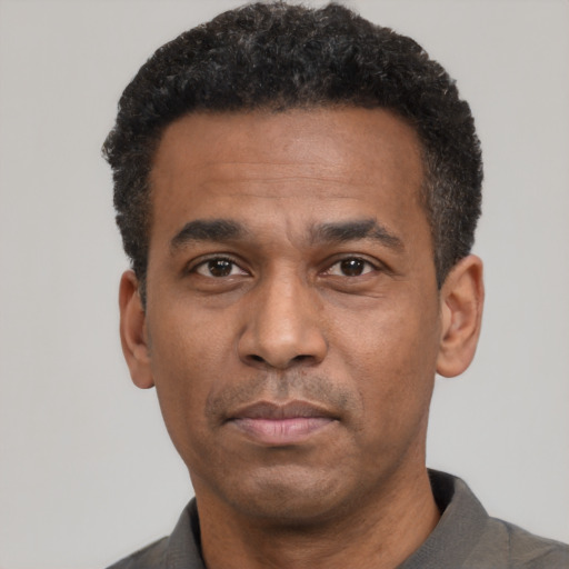 Neutral latino adult male with short  black hair and brown eyes