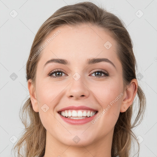 Joyful white young-adult female with long  brown hair and grey eyes