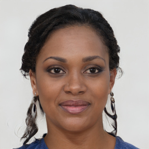 Joyful black young-adult female with medium  brown hair and brown eyes