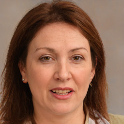 Joyful white adult female with medium  brown hair and grey eyes