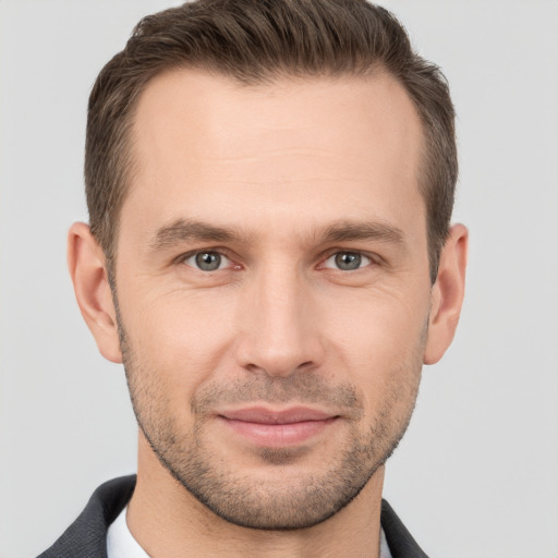 Joyful white young-adult male with short  brown hair and brown eyes