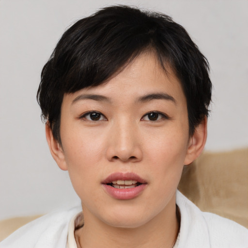 Joyful asian young-adult female with short  black hair and brown eyes
