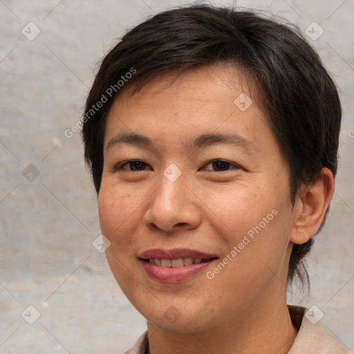 Joyful asian young-adult female with short  brown hair and brown eyes