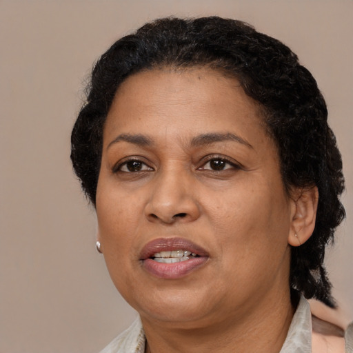 Joyful black adult female with medium  black hair and brown eyes