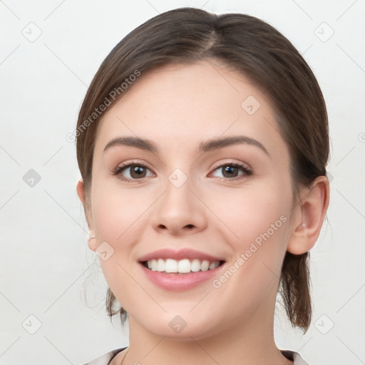 Joyful white young-adult female with medium  brown hair and grey eyes