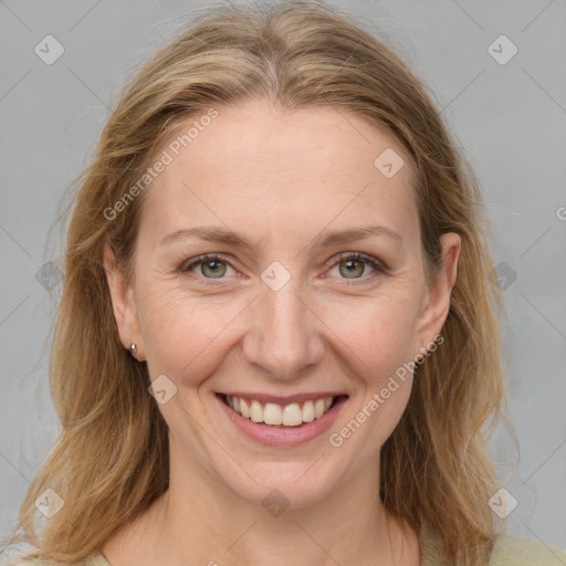 Joyful white adult female with medium  brown hair and grey eyes