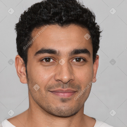 Joyful latino young-adult male with short  brown hair and brown eyes