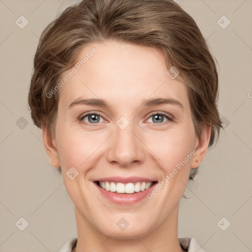 Joyful white young-adult female with short  brown hair and grey eyes