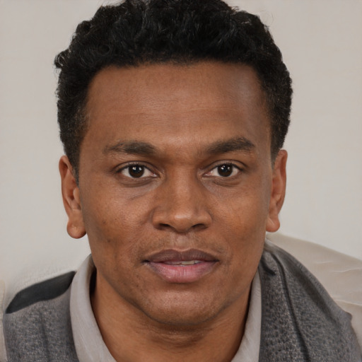 Neutral black adult male with short  brown hair and brown eyes