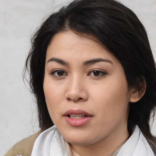 Joyful asian young-adult female with medium  black hair and brown eyes