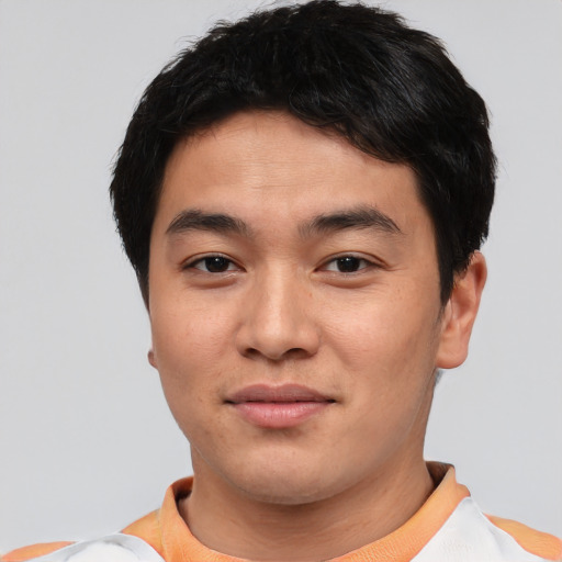 Joyful asian young-adult male with short  brown hair and brown eyes