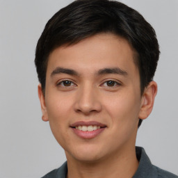 Joyful asian young-adult male with short  brown hair and brown eyes