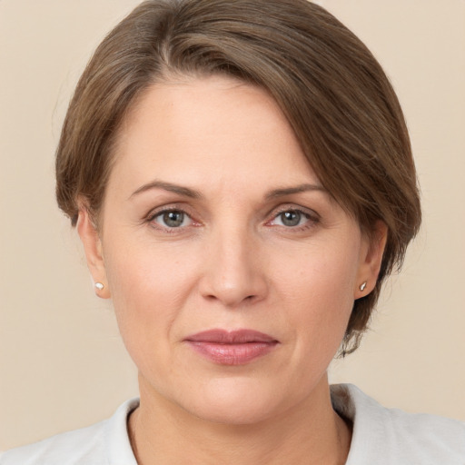 Joyful white adult female with medium  brown hair and brown eyes