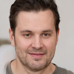 Joyful white adult male with short  brown hair and grey eyes