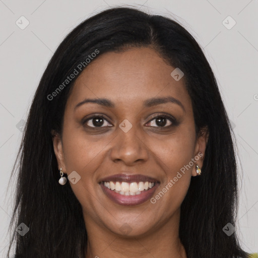 Joyful black young-adult female with long  brown hair and brown eyes