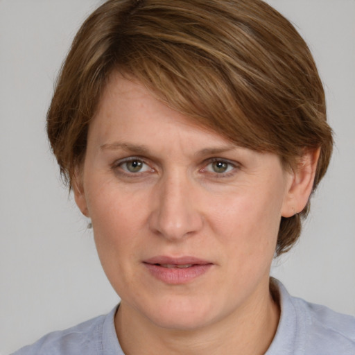 Joyful white adult female with medium  brown hair and grey eyes