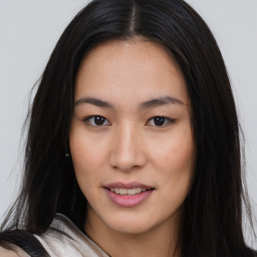 Joyful asian young-adult female with long  brown hair and brown eyes