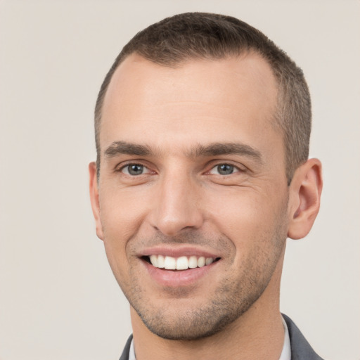 Joyful white young-adult male with short  brown hair and brown eyes