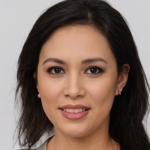 Joyful latino young-adult female with long  brown hair and brown eyes