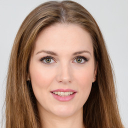 Joyful white young-adult female with long  brown hair and green eyes