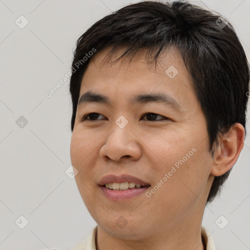 Joyful asian young-adult male with short  brown hair and brown eyes